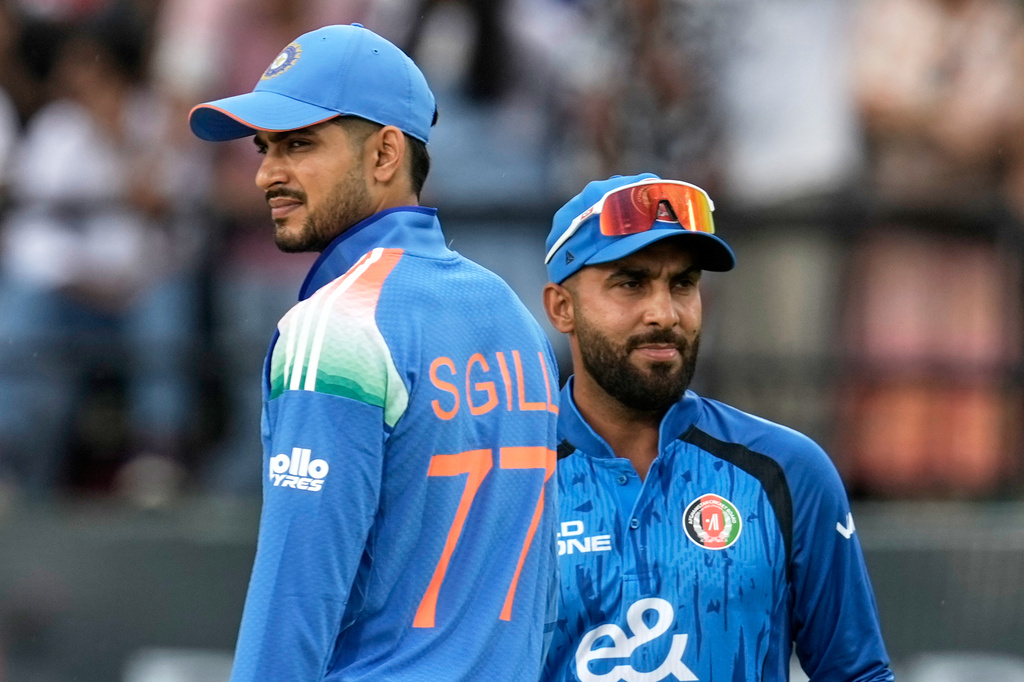 India's captain Shubman Gill, left, and Afghanistan's captain Hashmatullah Shahidi after the coin toss ahead of the first ODI cricket match between Afghanistan and India in Dharamshala, India, Saturday, June 13, 2026. (AP Photo/Ashwini Bhatia)