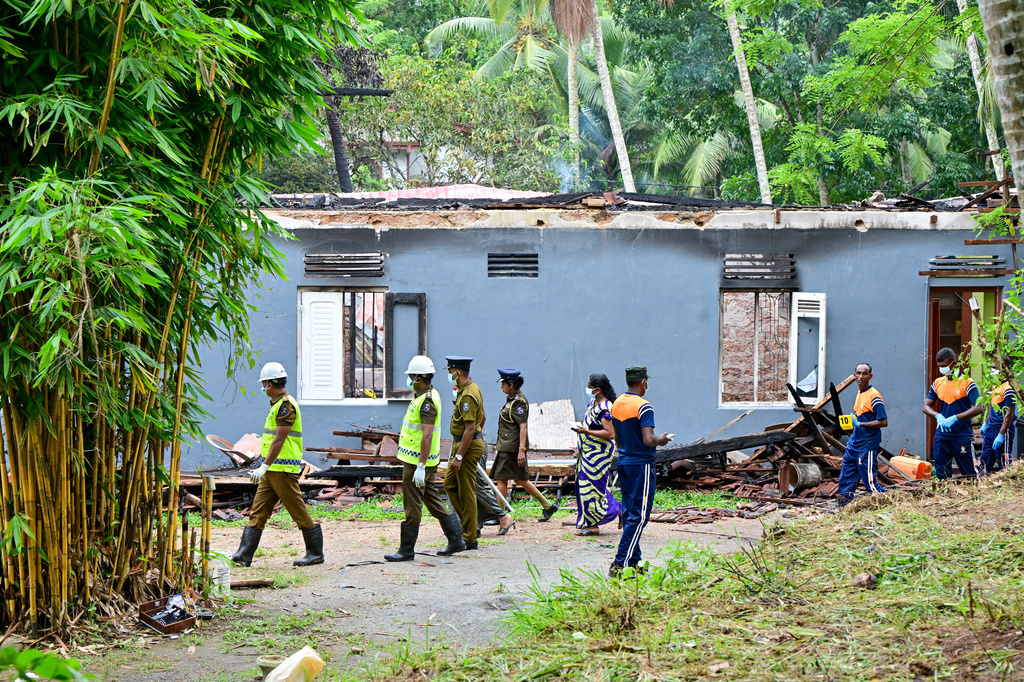 Sri Lankan police and judiciary officials inspect a charred elderly care home following an overnight fire in Anguruwatota, Sri Lanka, Thursday, June 4, 2026.(AP Photo)