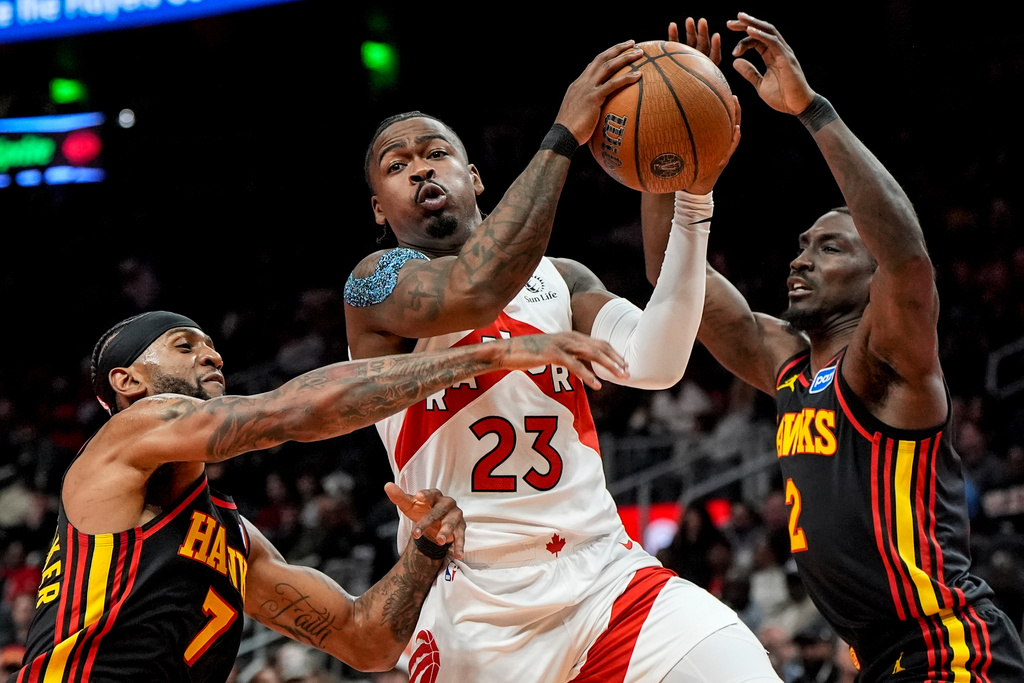 Toronto Raptors guard Jamal Shead (23) drives against Atlanta Hawks guard Keaton Wallace (2) during the first half of an NBA basketball game, Friday, Nov. 7, 2025, in Atlanta. (AP Photo/Mike Stewart)