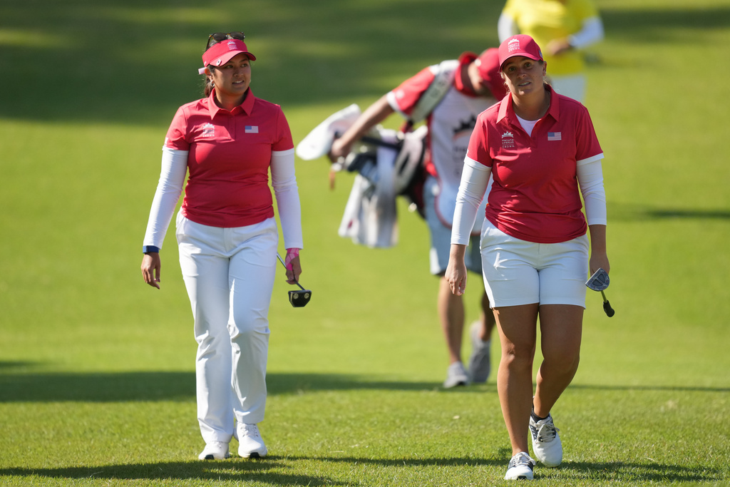 Lauren Coughlin, right, and Lilia Vu of the United States, walk to the first green during the pool A match against China team for the LPGA International Crown golf tournament at the New Korea Country Club in Goyang, South Korea, Thursday, Oct. 23, 2025. (AP Photo/Lee Jin-man)