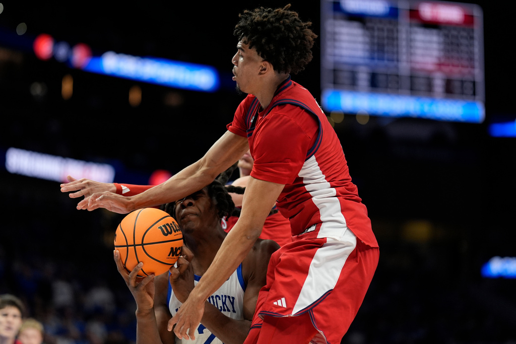 Kentucky guard Jasper Johnson (2) shoots against St. John's guard Oziyah Sellers (4) during the first half of an NCAA basketball game, Saturday, Dec. 20, 2025, in Atlanta. (AP Photo/Mike Stewart)