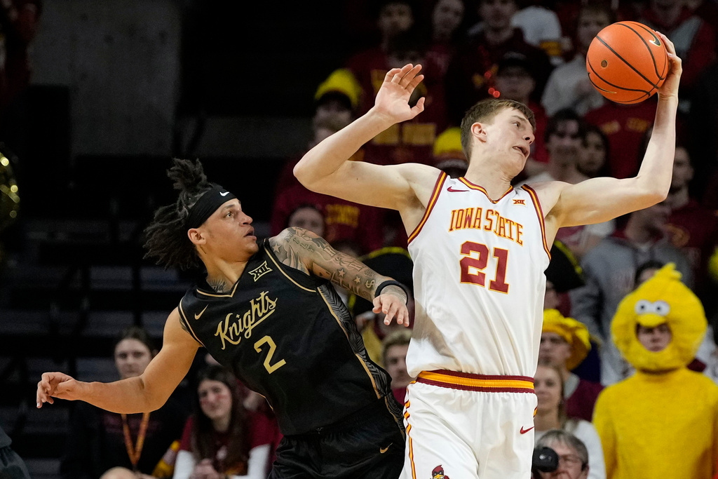 Iowa State forward Dominykas Pleta (21) catches a pass over Central Florida guard Riley Kugel (2) during the first half of an NCAA college basketball game, Tuesday, Jan. 20, 2026, in Ames, Iowa. (AP Photo/Charlie Neibergall)