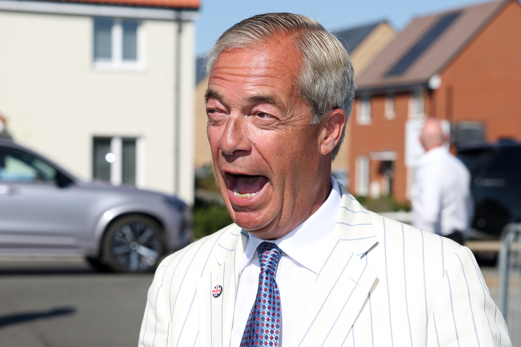 Britain's Reform UK party leader Nigel Farage arrives at a polling station in Walton on the Naze, Thursday, Aug. 13, 2026 to cast his vote for the Clacton on Sea by-election.(AP Photo/Richard Pelham)