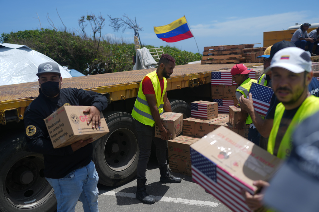Relief workers unload U.S. humanitarian aid for people affected by the earthquakes in La Guaira, Venezuela, Wednesday, July 8, 2026. (AP Photo/Ariana Cubillos)
