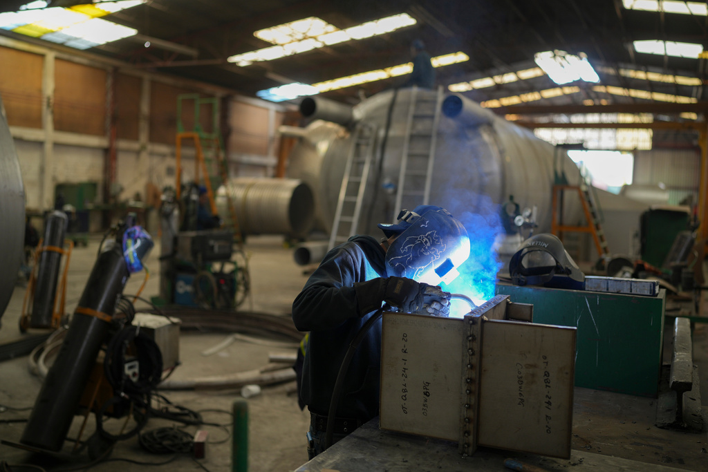 FILE - An employee welds metal at a steel tank factory in Mexico City, Feb. 11, 2025. (AP Photo/Eduardo Verdugo, File)