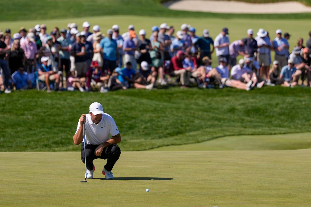 Scottie Scheffler lines up his shot on the 10th green during the third round of the PGA Championship golf tournament at Aronimink Golf Club, Saturday, May 16, 2026, in Newtown Square, PA. (AP Photo/Matt Slocum)