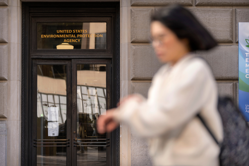 FILE - A person walks past the headquarters building of the Environmental Protection Agency, March 12, 2025, in Washington. (AP Photo/Mark Schiefelbein, File)