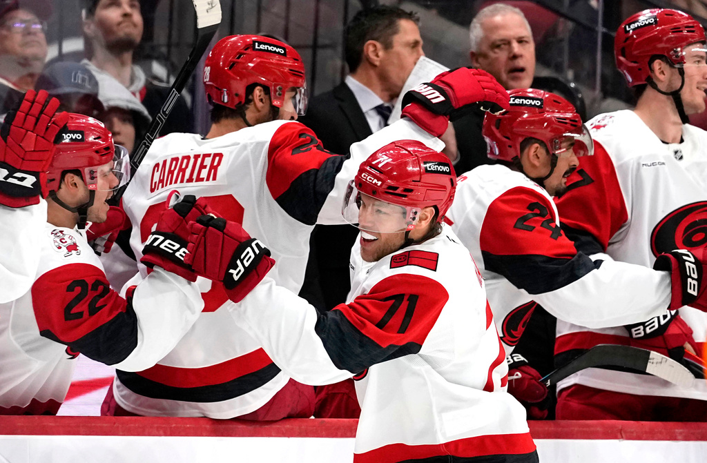 Carolina Hurricanes' Taylor Hall (71) celebrates at the benc after scoring a goal against the Ottawa Senators during the second period in Game 4 of a first-round NHL Stanley Cup playoff hockey series, Saturday, April 25, 2026, in Ottawa, Ontario. (Justin Tang/The Canadian Press via AP)