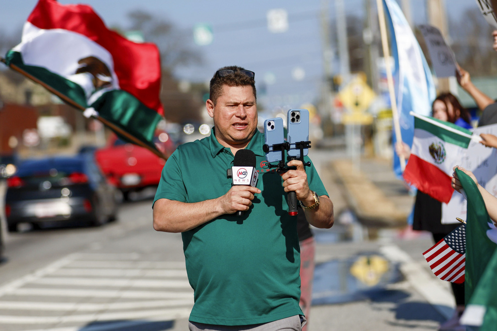 Mario Guevara, the metro Atlanta-based Spanish-language reporter, covers a protest against immigration enforcement on Buford Highway, Ga., on Saturday, Feb. 1, 2025. (Miguel Martinez/Atlanta Journal-Constitution via AP)