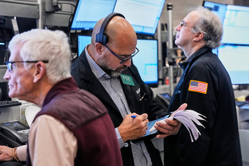 Options trader Steven Rodriguez, center, works on the floor of the New York Stock Exchange, Monday, Oct. 20, 2025. (AP Photo/Richard Drew) Options trader Steven Rodriguez, center, works on the floor of the New York Stock Exchange, Monday, Oct. 20, 2025. (AP Photo/Richard Drew)