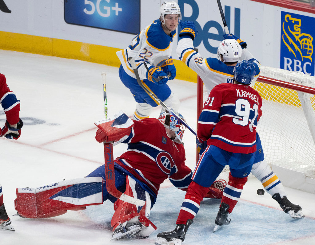 Buffalo Sabres' Tyson Kozak (48) celebrates his goal over Montreal Canadiens goaltender Jakub Dobes (75) with teammate Jack Quinn (22) as Canadiens' Oliver Kapanen (91) skates in during third period NHL hockey action in Montreal on Monday, Oct. 20, 2025. (Christinne Muschi/The Canadian Press via AP)