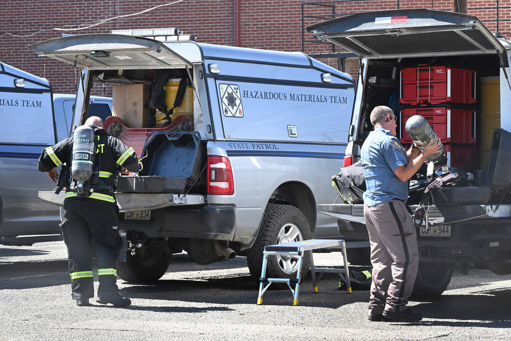 Members of the Colorado State Highway Patrol hazmat team get ready to enter the Davis Mortuary, Thursday, Aug. 21, 2025, in Pueblo, Colo. (Jerilee Bennett/The Gazette via AP)