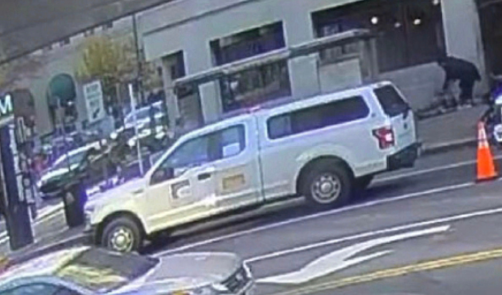 This image contained in a court filing by the Department of Justice on Tuesday, Dec. 2, 2025 shows the the defendant, Rahmanullah Lakanwal, top right, bending down next to Specialist Sarah Beckstrom and Staff Sgt. Andrew Wolfe after shooting them, according to police. (Department of Justice via AP)