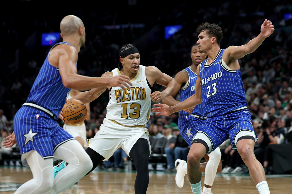 Boston Celtics forward Ron Harper Jr. (13) drives to the net as Orlando Magic forward Tristan da Silva (23) defends during the first half of an NBA basketball game, Sunday, April 12, 2026, in Boston. (AP Photo/Mark Stockwell)
