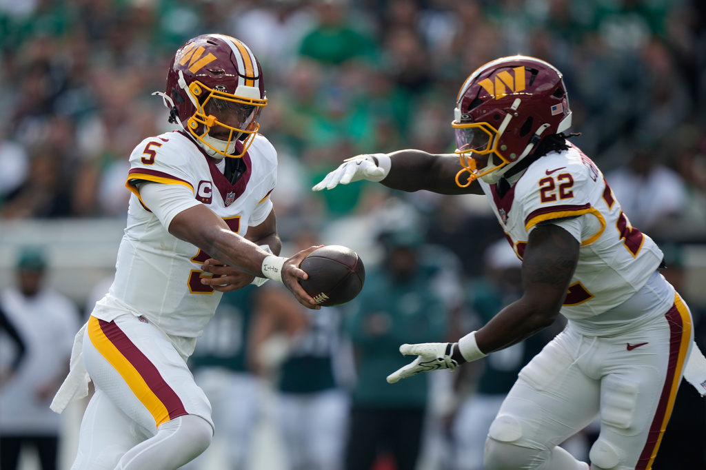 Washington Commanders quarterback Jayden Daniels (5) hands off to running back Jacory Croskey-Merritt (22) during the first half of an NFL football game against the Philadelphia Eagles, Sunday, Sept. 13, 2026, in Philadelphia. (AP Photo/Matt Slocum)
