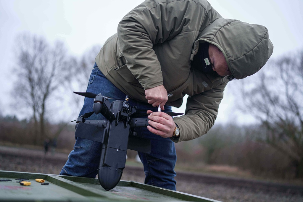 A serviceman prepares an interceptor drone of "General Cherry" company before a flight at the polygon in Ukraine, on Dec. 4, 2025. (AP Photo/Evgeniy Maloletka)