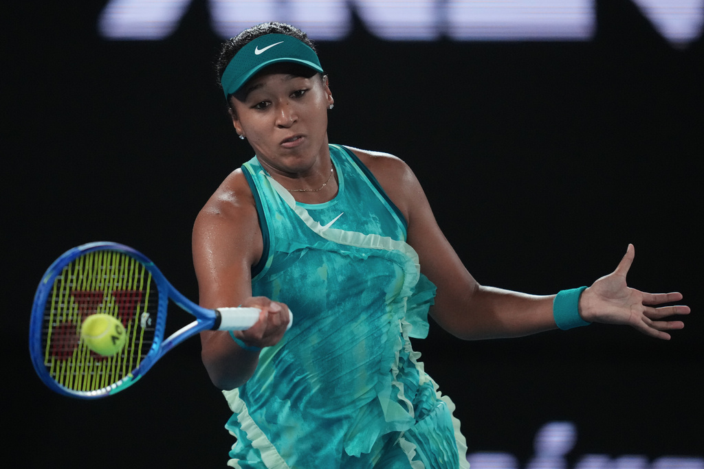 Naomi Osaka of Japan plays a forehand return to Antonia Ruzic of Croatia during their first round match at the Australian Open tennis championship in Melbourne, Australia, Tuesday, Jan. 20, 2026. (AP Photo/Asanka Brendon Ratnayake)
