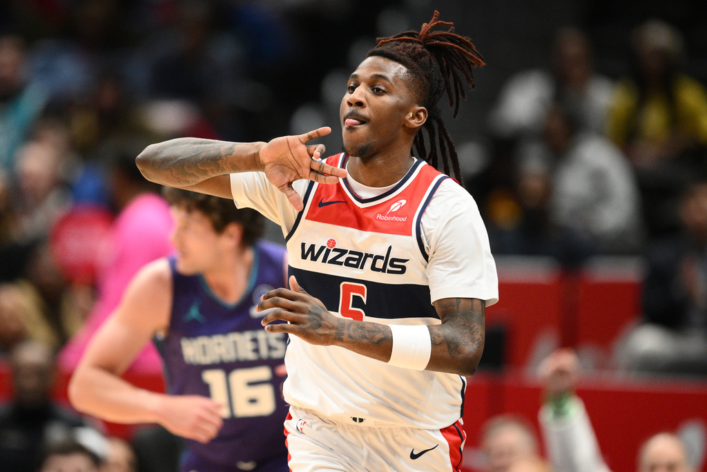 Washington Wizards guard Jamir Watkins gestures after he made a 3-point basket during the first half of an NBA basketball game against the Charlotte Hornets, Sunday, Feb. 22, 2026, in Washington. (AP Photo/Nick Wass)