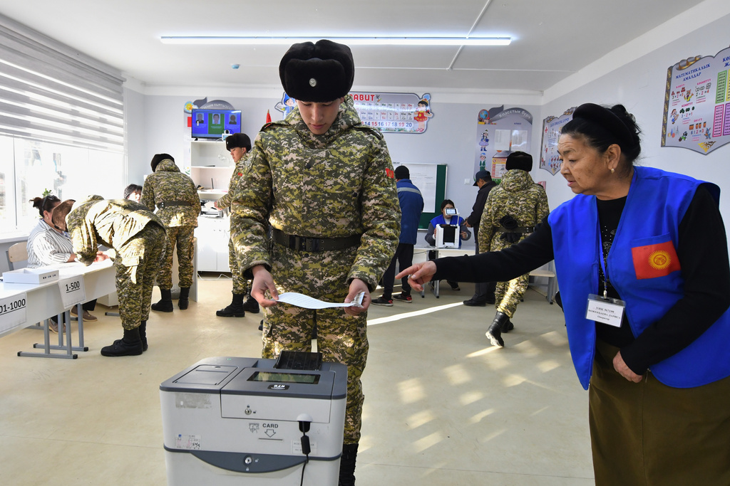 A Kyrgyz Army soldier casts his ballot during the parliamentary elections at a polling station in Tash-Dobo, 19 km (11 miles) south of Bishkek, Kyrgyzstan, Sunday, Nov. 30, 2025. (AP Photo/Vladimir Voronin)