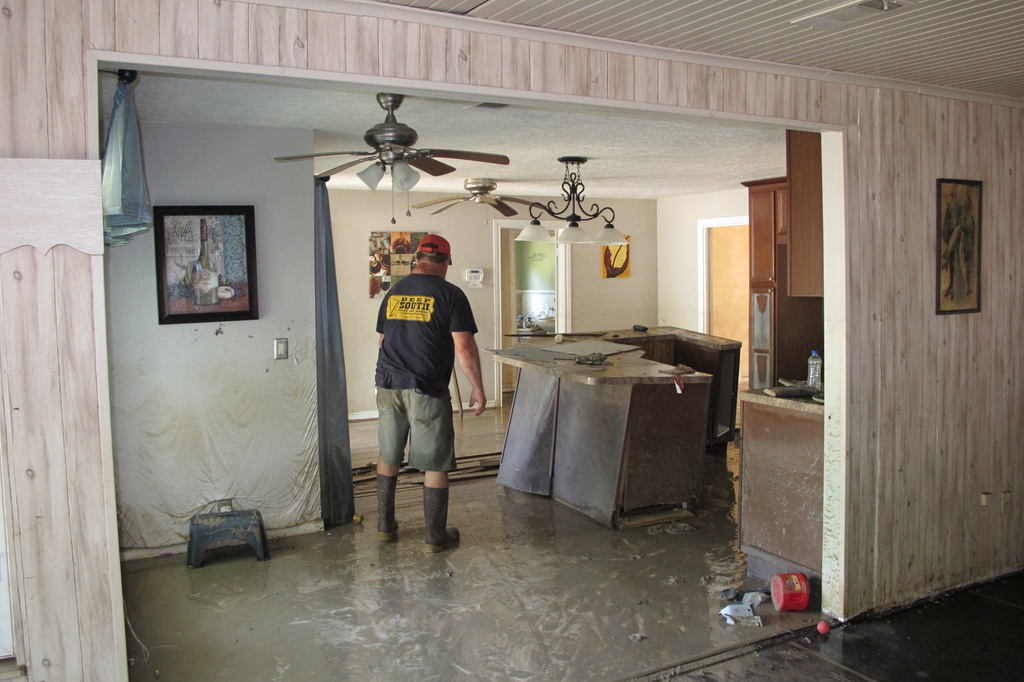 FILE - Dwight Chandler walks through his devastated home from Hurricane Harvey not too far from old acid pits that were designated as a U.S. EPA Superfund in Highlands, Texas, Aug. 31, 2017. (AP Photo/Jason Dearen, File)