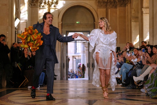 Designer Andreas Kronthaler, left, accepts applause as he holds the hand of Heidi Klum as part of the Vivienne Westwood Spring/Summer 2026 collection presented in Paris, Saturday, Oct. 4, 2025. (AP Photo/Aurelien Morissard) Designer Andreas Kronthaler, left, accepts applause as he holds the hand of Heidi Klum as part of the Vivienne Westwood Spring/Summer 2026 collection presented in Paris, Saturday, Oct. 4, 2025. (AP Photo/Aurelien Morissard)