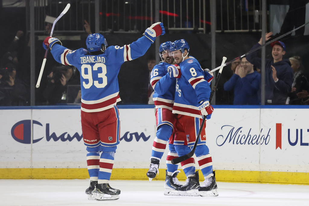 The New York Rangers celebrate an overtime goal by J.T. Miller (8) during an NHL hockey game against the Montréal Canadiens, Saturday, Dec. 13, 2025, in New York. (AP Photo/Heather Khalifa)