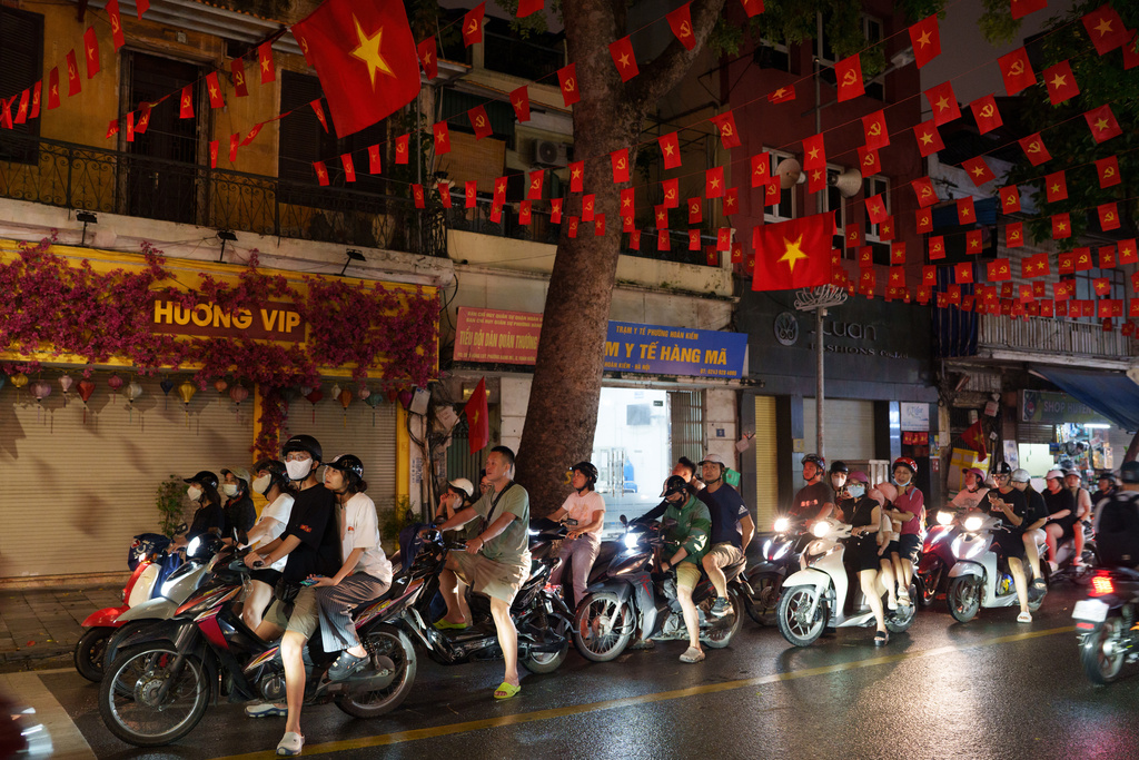 CORRECTS TO CALL THE AREA THE OLD QUARTER - Vietnamese ride their two-wheelers in the Old Quarter area in Hanoi, Vietnam, on Aug. 30, 2025. (AP Photo/Vincent Thian)