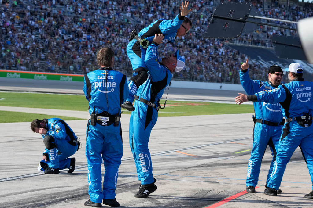 Driver Chase Elliott's pit crew celebrates after he won a NASCAR Cup Series auto race in Fort Worth, Texas, Sunday, May 3, 2026. (AP Photo/Larry Papke)