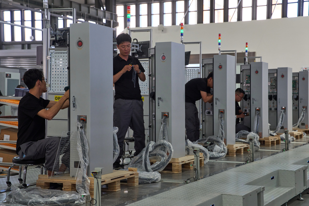 FILE - Workers assemble charging stations at the Mengma Intelligent Transportation Equipment Manufacturing Base in Hohot in northern China's Inner Mongolia province on Thursday, June 11, 2026. (AP Photo/Ng Han Guan, file)