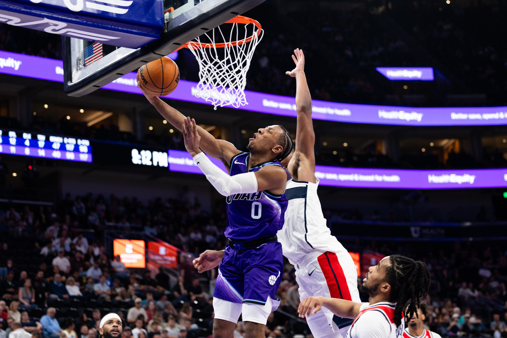 Utah Jazz forward Kennedy Chandler (0) shoots a layup during the second half of an NBA basketball game against the Washington Wizards, Wednesday, March 25, 2026, in Salt Lake City. (AP Photo/Anna Fuder)