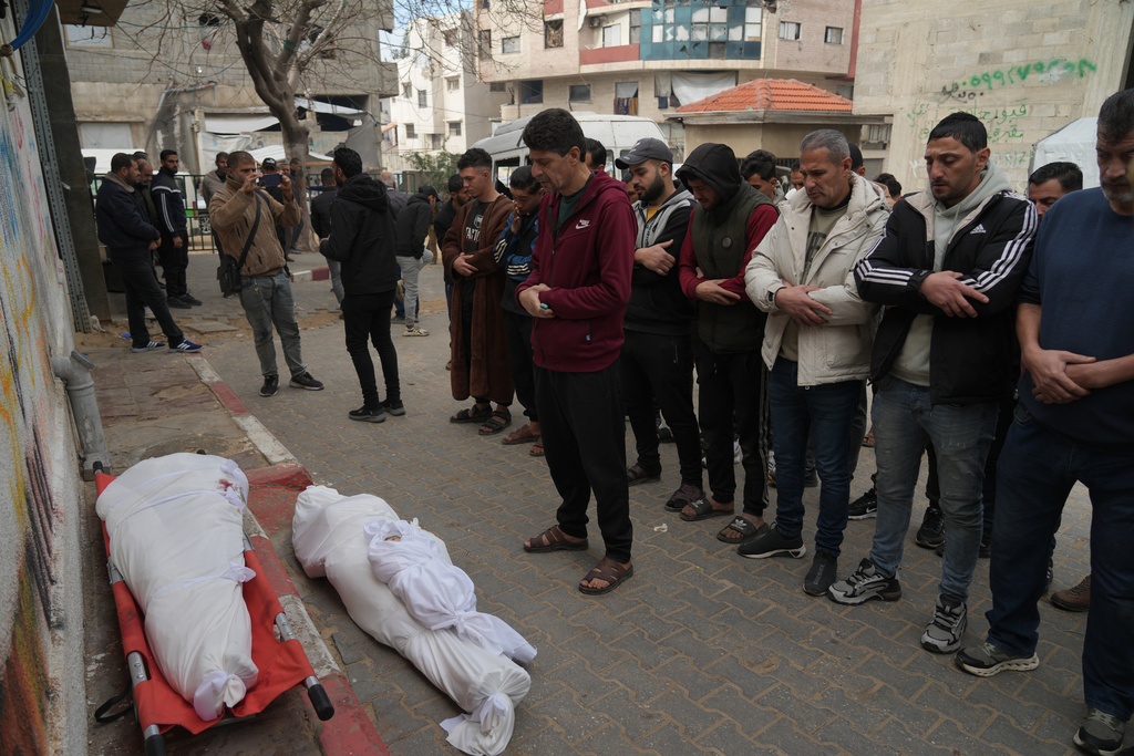 Palestinians mourn over the dead who were killed in an Israeli military strike, at Shifa Hospital in Gaza City, Wednesday, Feb. 4, 2026. (AP Photo/Jehad Alshrafi)