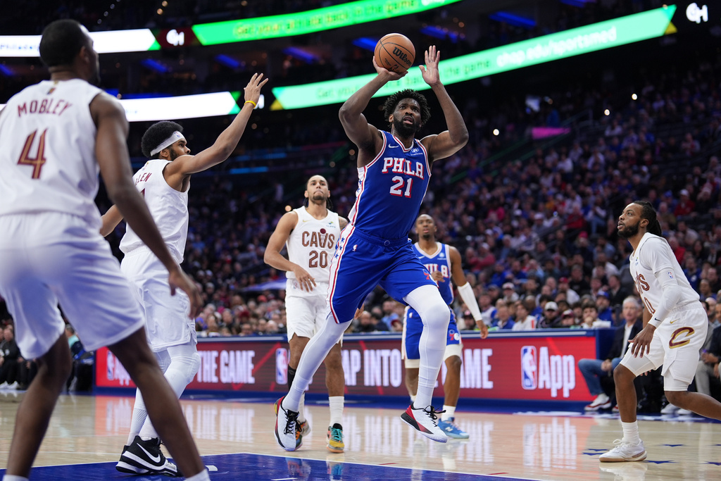 Philadelphia 76ers' Joel Embiid (21) goes up for a shot during the first half of an NBA basketball game against the Cleveland Cavaliers Wednesday, Jan. 14, 2026, in Philadelphia. (AP Photo/Matt Slocum)