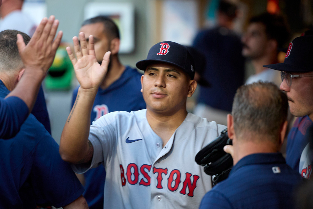 Boston Red Sox starting pitcher Ranger Suarez is greeted in the dugout after leaving during the seventh inning against the Seattle Mariners of a baseball game, Friday, June 19, 2026, in Seattle. (AP Photo/John Froschauer)