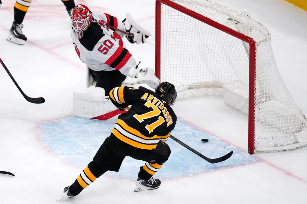 Boston Bruins left wing Viktor Arvidsson (71) scores on New Jersey Devils goaltender Nico Daws (50) during the first period of a hockey game, Tuesday, April 14, 2026, in Boston. (AP Photo/Charles Krupa)