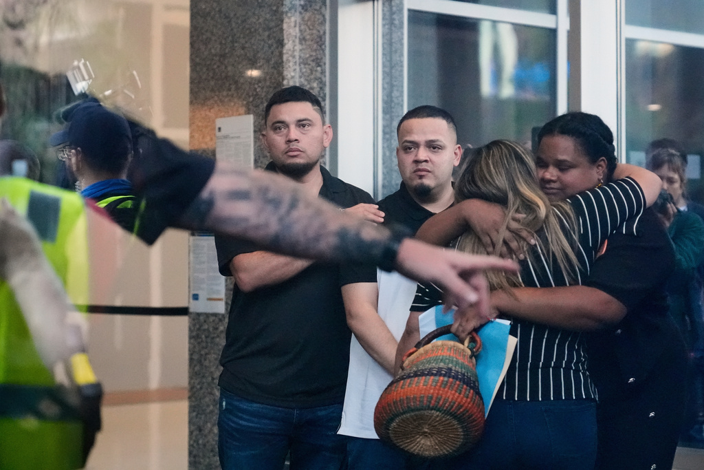 Kilmar Abrego Garcia, center, and his brother Cesar Abrego Garcia, left, arrive at the Immigration and Customs Enforcement field office in Baltimore, Aug. 25, 2025. (AP Photo/Stephanie Scarbrough, File)