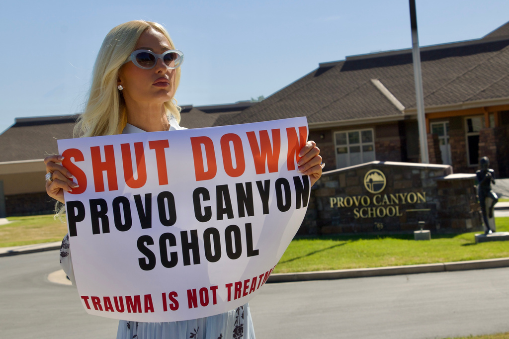 FILE - Paris Hilton protests outside the Provo Canyon School, where she says she suffered abuse as a teen, Monday, June 15, 2026, in Springville, Utah. (AP Photo/Hannah Schoenbaum, File)