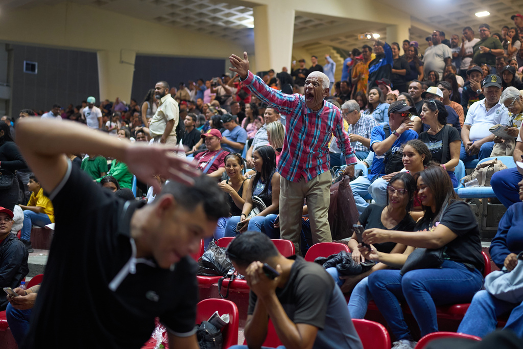 Spectators watch horse races during the 56th Jockey Challenge at the Rinconada racetrack in Caracas, Venezuela, Sunday, Dec. 14, 2025. (AP Photo/Arian Cubillos)