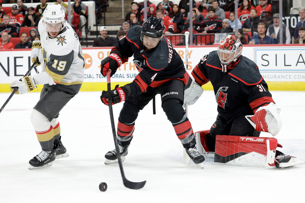FILE - Carolina Hurricanes defenseman Shayne Gostisbehere (4) and goaltender Frederik Andersen (31) defend Vegas Golden Knights right wing Reilly Smith (19) during the first period of an NHL hockey game, Oct. 28, 2025, in Raleigh, N.C. (AP Photo/Chris Seward, file)