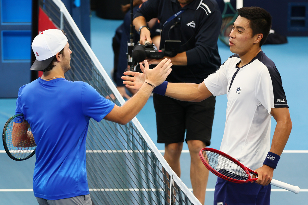 Brandon Nakashima, of the United States, right, shakes hands at the net after he beat Aleksandar Kovacevic, of the United States, left, in their semifinal match at the Brisbane International tennis tournament in Brisbane, Australia, Saturday, Jan. 10, 2026. (AP Photo/Tertius Pickard)