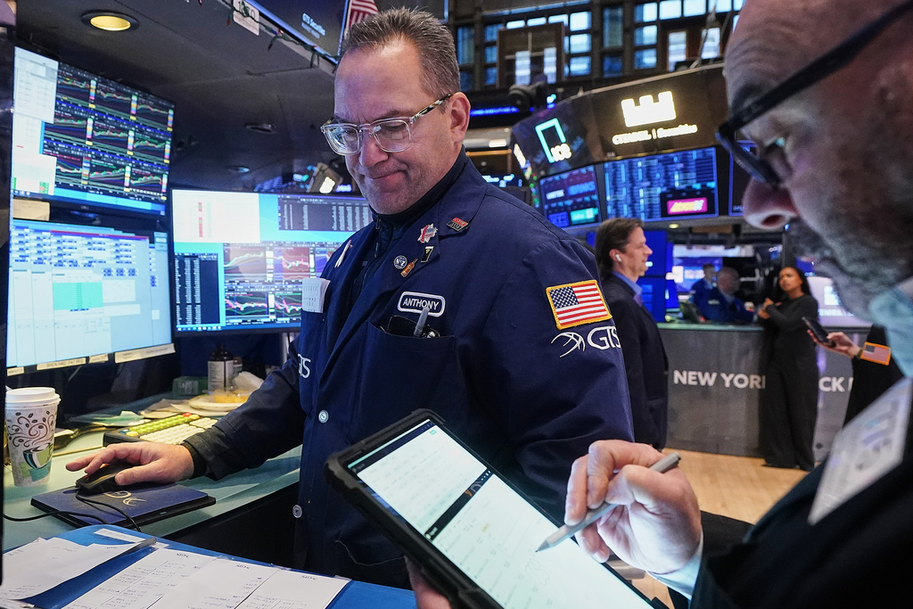 Specialist Anthony Matesic, left, and trader Fred Demarco work on the floor of the New York Stock Exchange, Tuesday, Jan. 20, 2026. (AP Photo/Richard Drew)