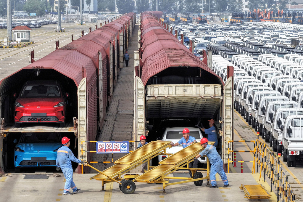 Workers prepare cars for shipment by rail in Yantai, eastern China's Shandong province, on June 20, 2026. (Chinatopix via AP)