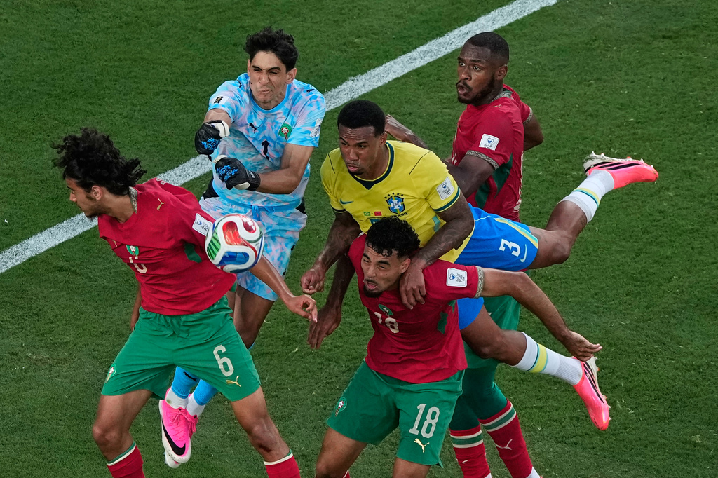 Morocco goalkeeper Yassine Bounou (1) punches the ball away from Brazil's Gabriel Magalhaes (3) as Morocco's Ayyoub Bouaddi (6), Chadi Riad (18) and Issa Diop get in on the play during the World Cup Group C soccer match in East Rutherford, N.J., near New York, Saturday, June 13, 2026. (AP Photo/Matt Slocum)