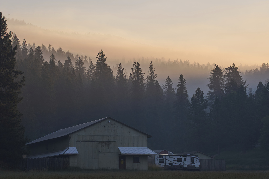 Smoke fills the air the day after a shooter ambushed and killed multiple firefighters responding to a wildfire at Canfield Mountain Monday, June 30, 2025, in Coeur D'Alene, Idaho. (AP Photo/Lindsey Wasson)