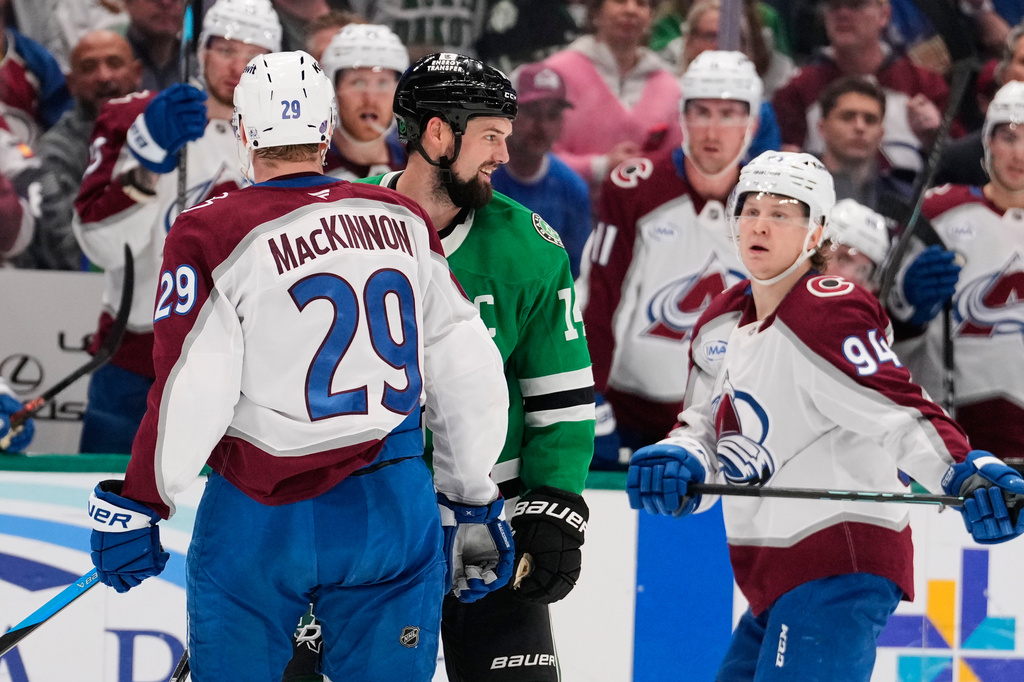 Colorado Avalanche's Nathan MacKinnon (29) and Dallas Stars' Jamie Benn (14) exchange words as Joel Kiviranta (94) looks on in the second period of an NHL hockey game Saturday, April 4, 2026, in Dallas. (AP Photo/Tony Gutierrez)