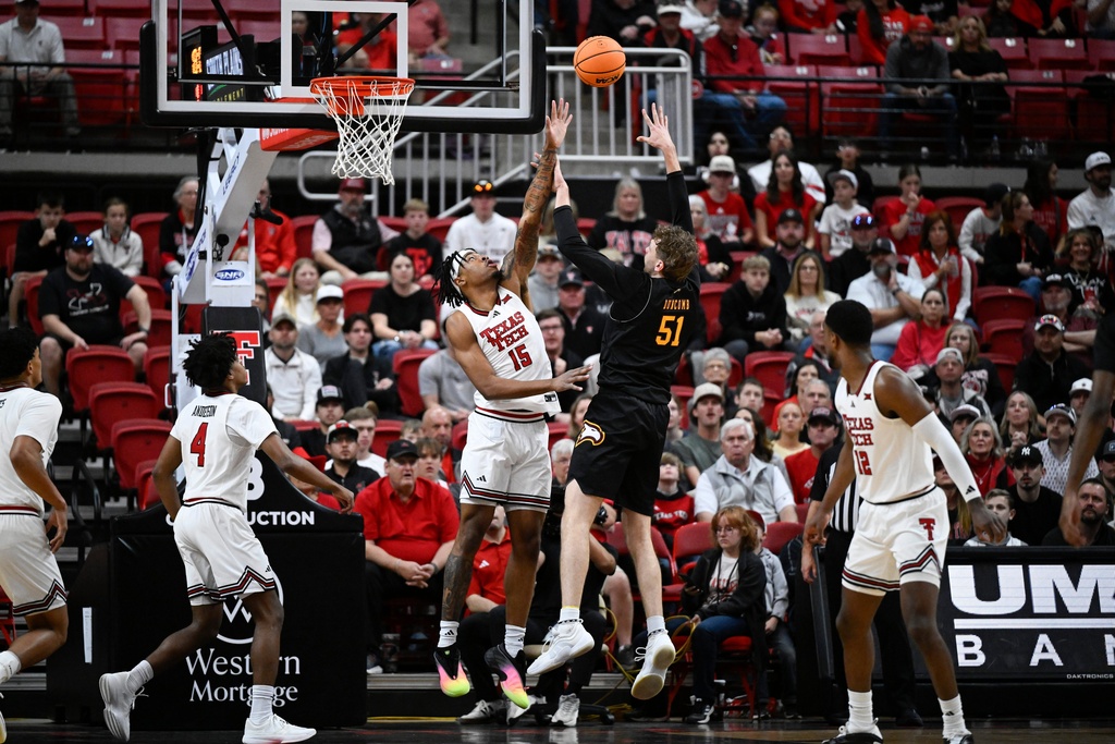 Winthrop center Logan Duncomb (51) attempts to shoot over Texas Tech forward JT Toppin (15) during the first half of an NCAA college basketball game Sunday, Dec. 28, 2025, in Lubbock, Texas. (AP Photo/Justin Rex)