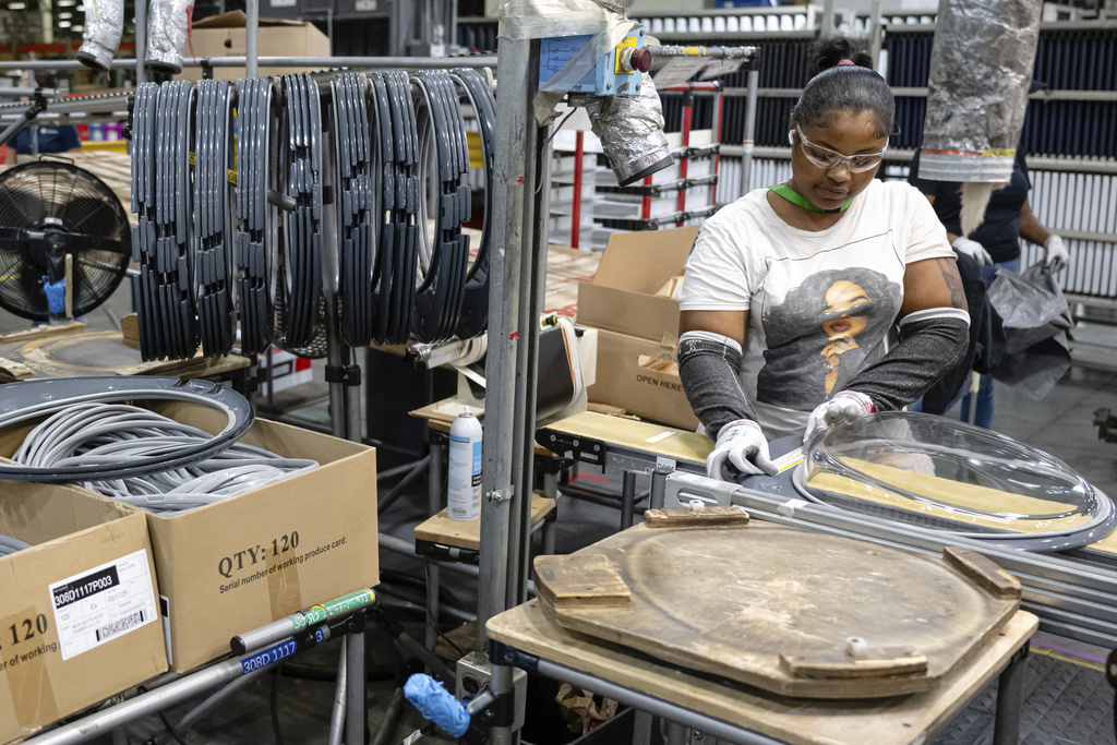 FILE - An employee pieces together components on an assembly line at GE Appliances global headquarters, Wednesday, Aug 13, 2025, in Louisville, Ky. (AP Photo/Jon Cherry, File)