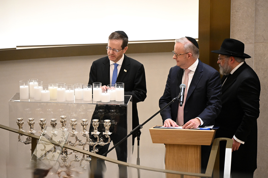 Israeli President Isaac Herzog, left, and Australian Prime Minister Anthony Albanese, center, attend a ceremony at the Chabad of Bondi in Sydney, Tuesday, Feb. 10, 2026. (Bianca De Marchi/Pool Photo via AP)