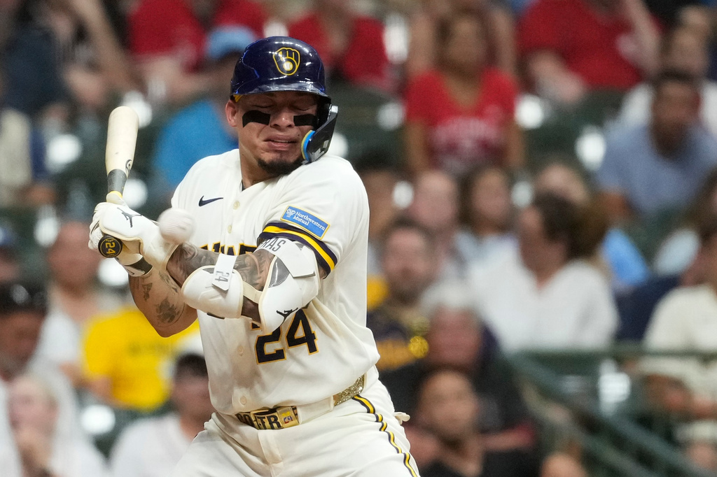 Milwaukee Brewers' William Contreras gets hit by a pitch during the eighth inning of a baseball game against the Cincinnati Reds, Wednesday, July 1, 2026, in Milwaukee. (AP Photo/Aaron Gash)