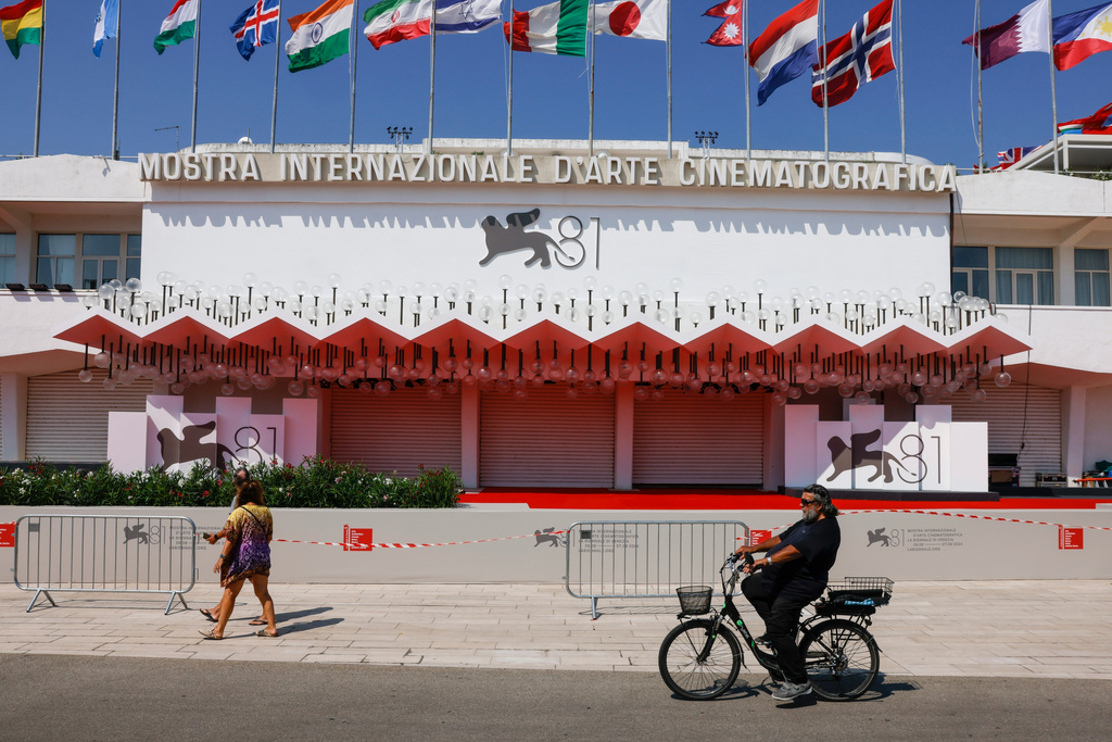 FILE - Festival goers pass the red carpet of the 81st edition of the Venice Film Festival in Venice, Italy, Aug. 27, 2024. (Photo by Vianney Le Caer/Invision/AP, File)