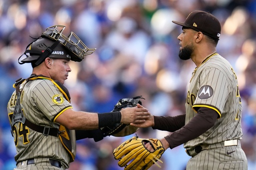 San Diego Padres' Robert Suarez and Freddy Fermin celebrate after Game 2 of a National League wild card baseball game against the Chicago Cubs Wednesday, Oct. 1, 2025, in Chicago. (AP Photo/Erin Hooley) San Diego Padres' Robert Suarez and Freddy Fermin celebrate after Game 2 of a National League wild card baseball game against the Chicago Cubs Wednesday, Oct. 1, 2025, in Chicago. (AP Photo/Erin Hooley)